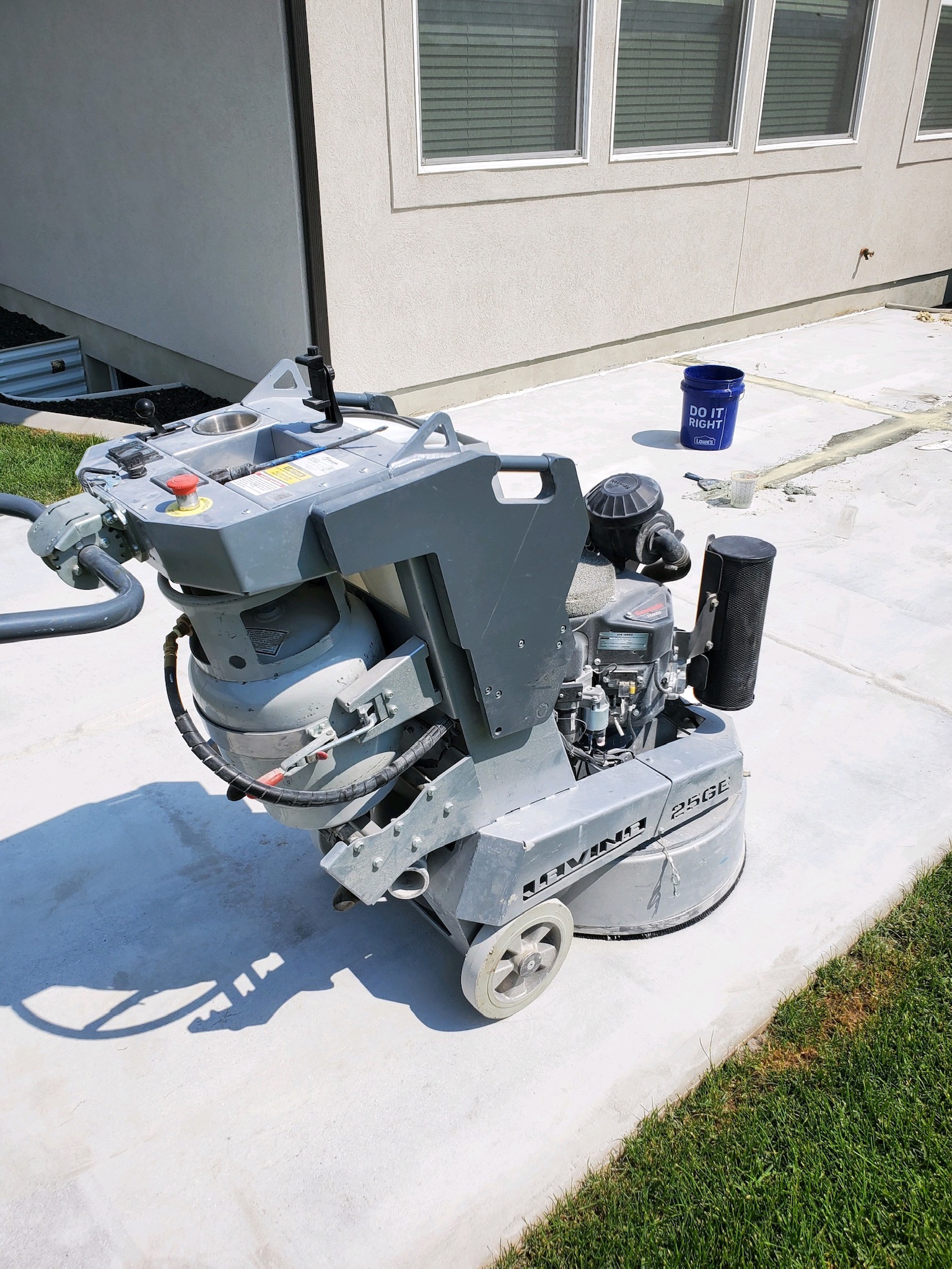 Commercial diamond grinder on exterior concrete patio surface prep - Sparks Coatings